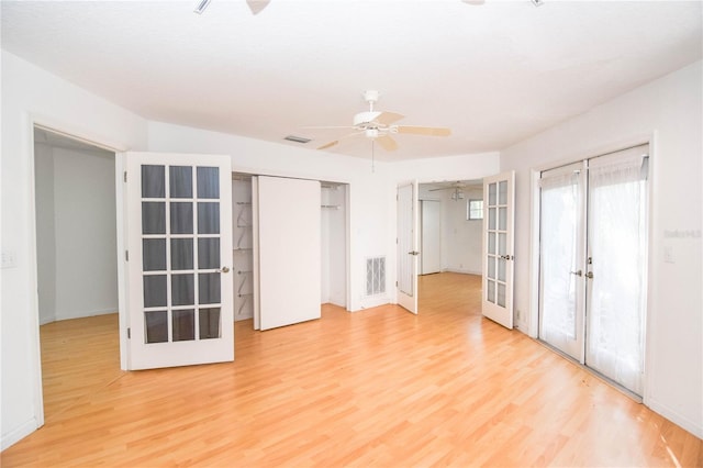 unfurnished bedroom with ceiling fan, light wood-type flooring, and french doors