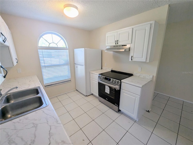 kitchen featuring white cabinets, white refrigerator, and stainless steel range with electric cooktop