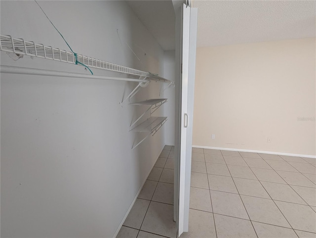 spacious closet featuring light tile patterned floors