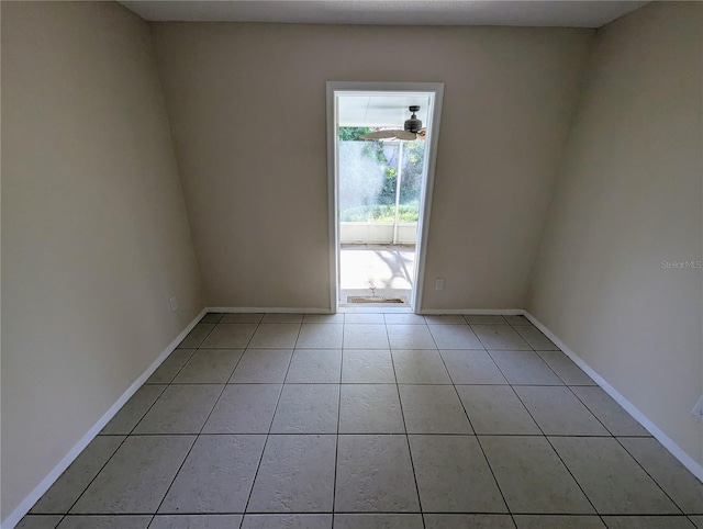 empty room featuring ceiling fan and light tile patterned flooring