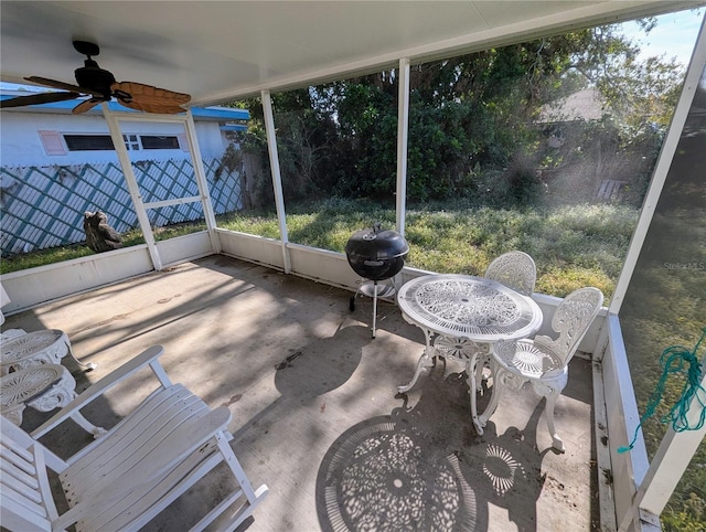 sunroom / solarium featuring ceiling fan