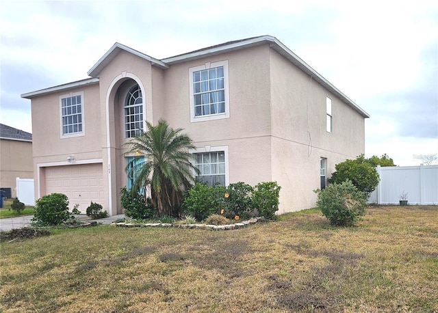 view of front of home featuring a front lawn and a garage