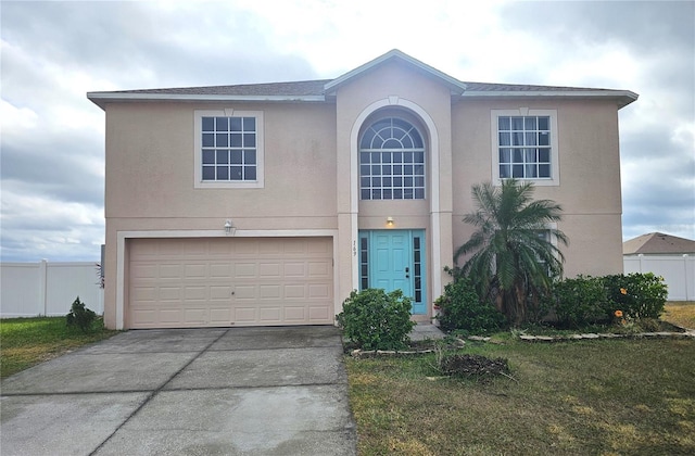 view of property with a garage and a front lawn