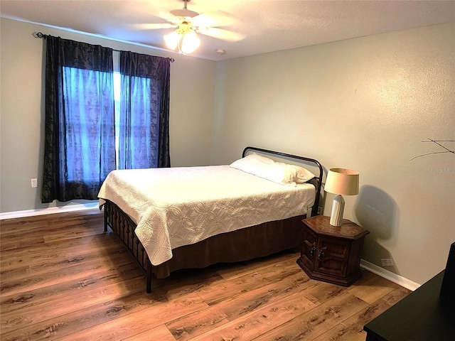 bedroom with ceiling fan and hardwood / wood-style floors