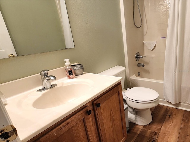 full bathroom with shower / bathtub combination with curtain, vanity, hardwood / wood-style flooring, and toilet