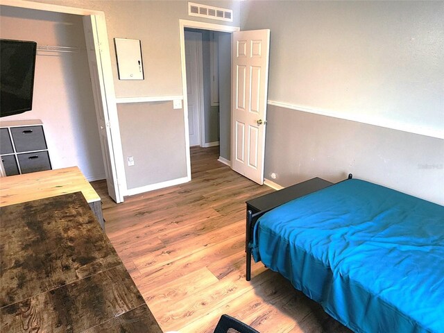 bedroom featuring a closet and hardwood / wood-style flooring