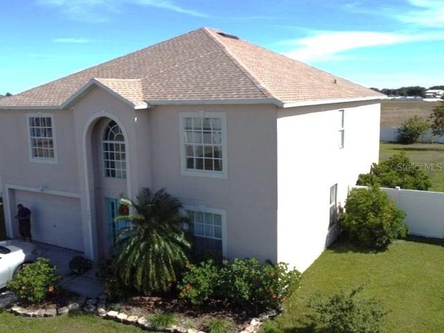 view of side of home featuring a yard and a garage