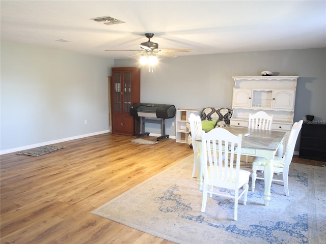 dining space with ceiling fan and light hardwood / wood-style floors