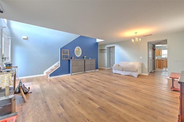 living room featuring light hardwood / wood-style flooring and a notable chandelier