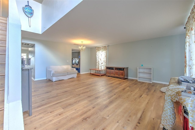 living room with a notable chandelier and light hardwood / wood-style floors