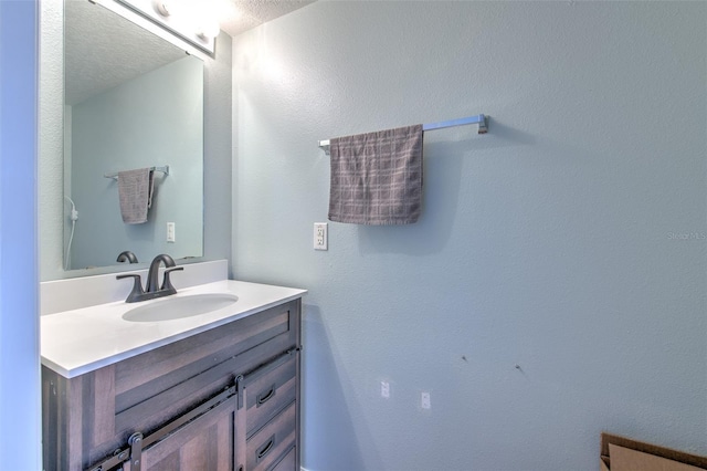 bathroom featuring vanity and a textured ceiling