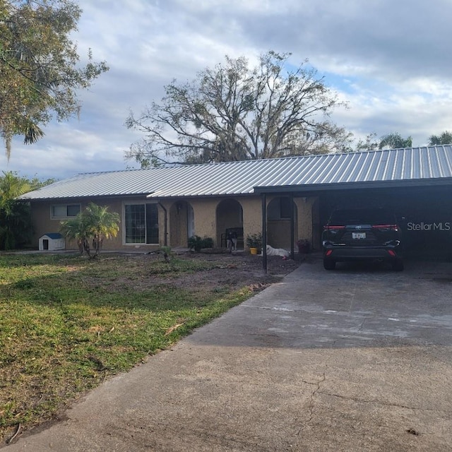 ranch-style house with a front yard and a carport