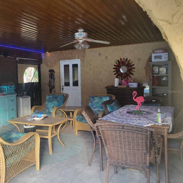 interior space with ceiling fan and light tile patterned floors