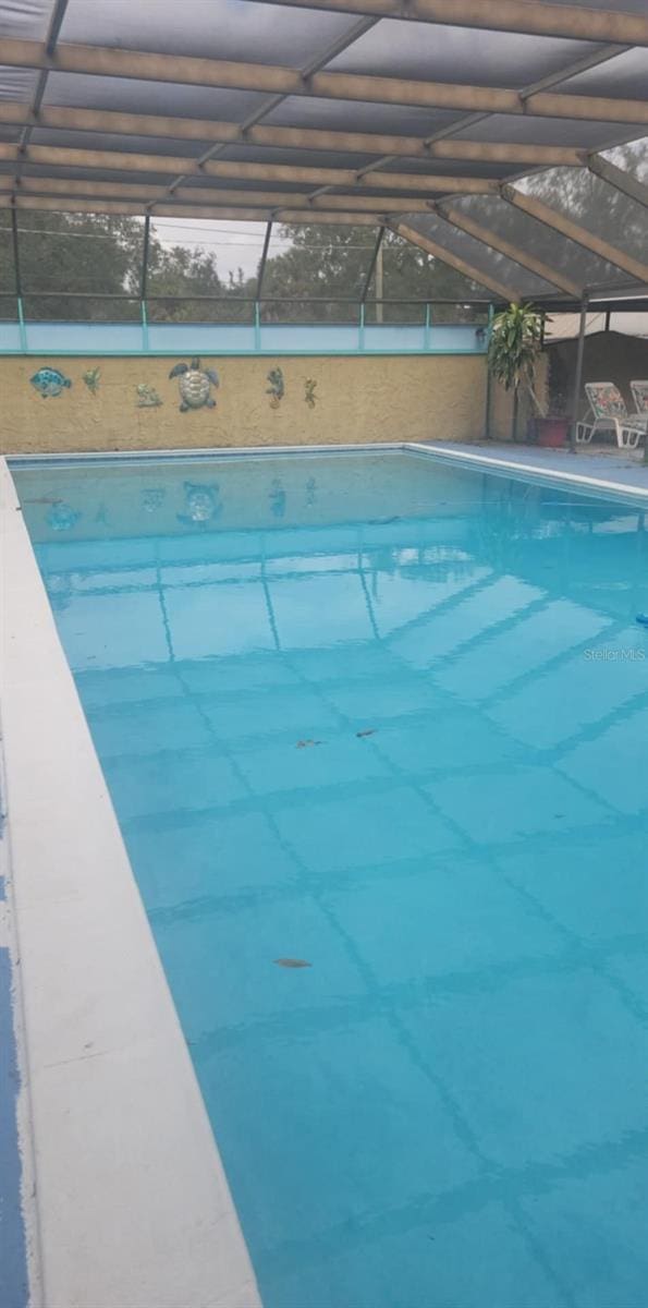 view of swimming pool with a lanai