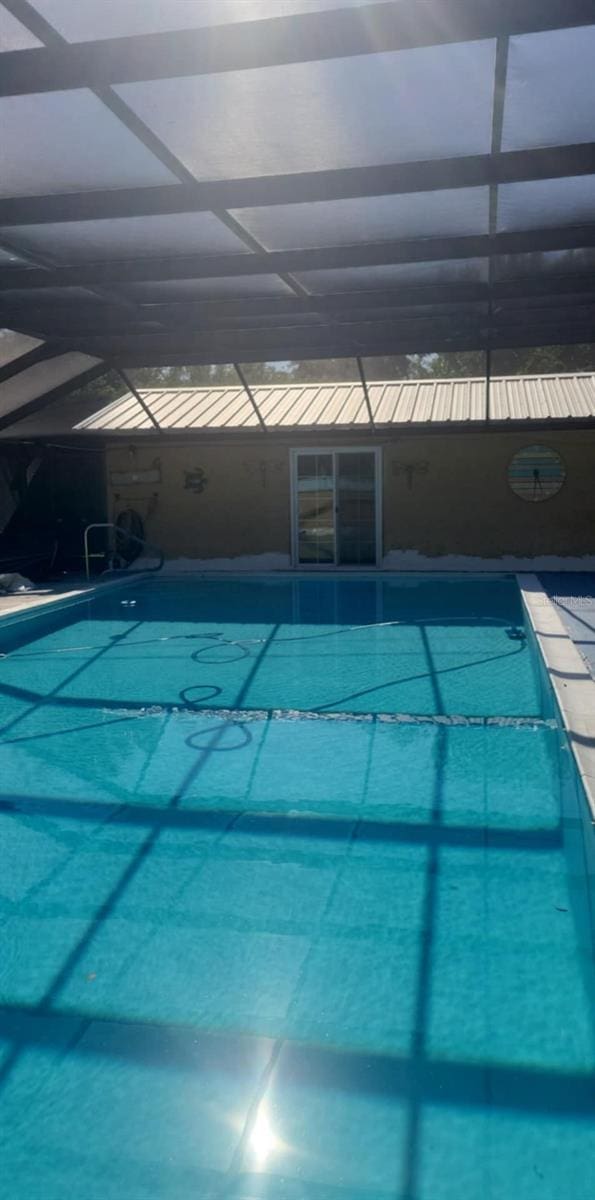 view of swimming pool with a lanai