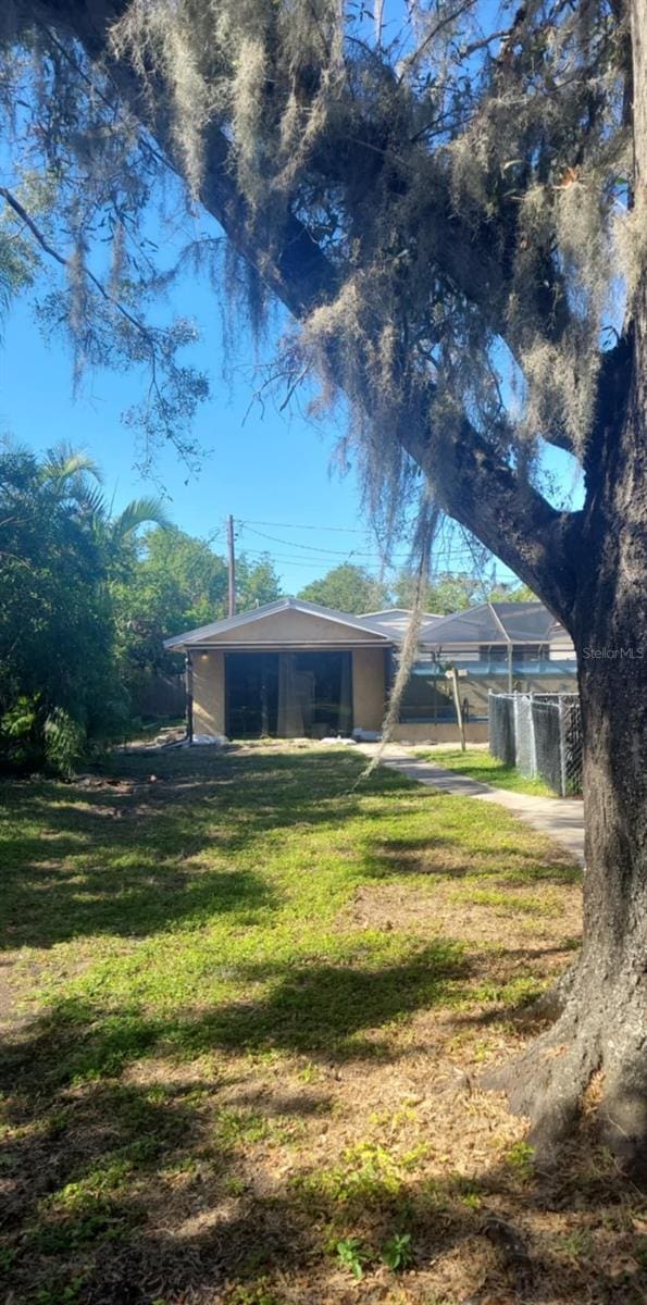 rear view of property featuring a yard