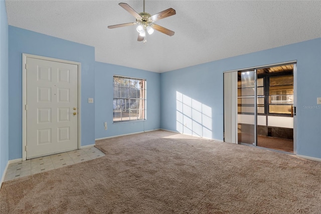 unfurnished room with light carpet and a textured ceiling