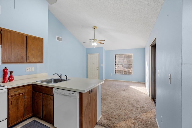 kitchen with ceiling fan, sink, kitchen peninsula, white appliances, and light carpet