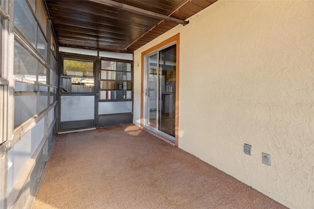 unfurnished sunroom with wood ceiling