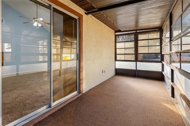 unfurnished sunroom featuring ceiling fan and wood ceiling