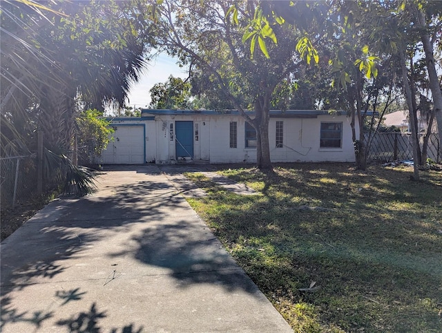 ranch-style house with a front yard and a garage