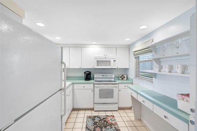 kitchen featuring white cabinets, white appliances, and light tile patterned floors