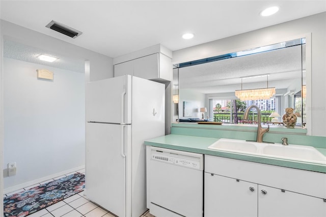 kitchen featuring white cabinetry, sink, hanging light fixtures, white appliances, and light tile patterned floors