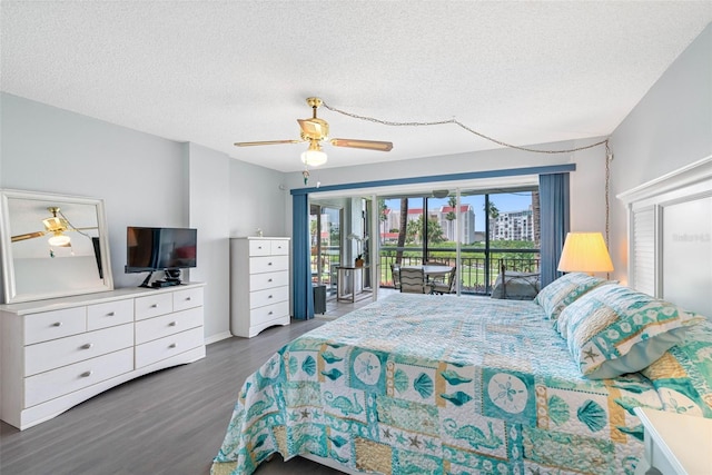 bedroom featuring access to exterior, ceiling fan, dark hardwood / wood-style flooring, and a textured ceiling