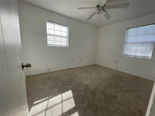 carpeted spare room with ceiling fan