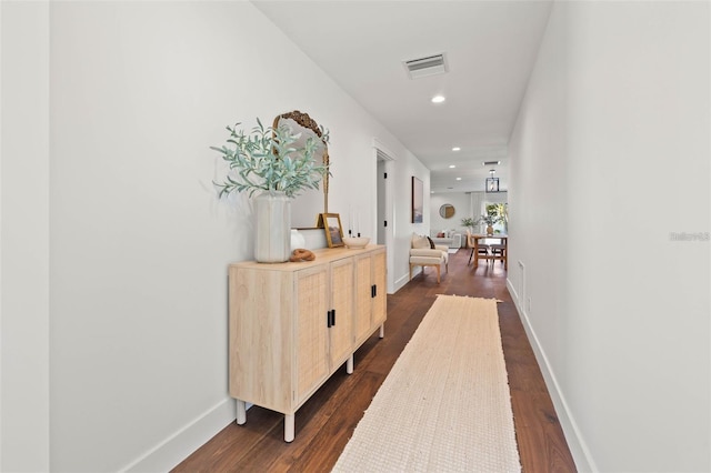 hallway featuring dark hardwood / wood-style flooring