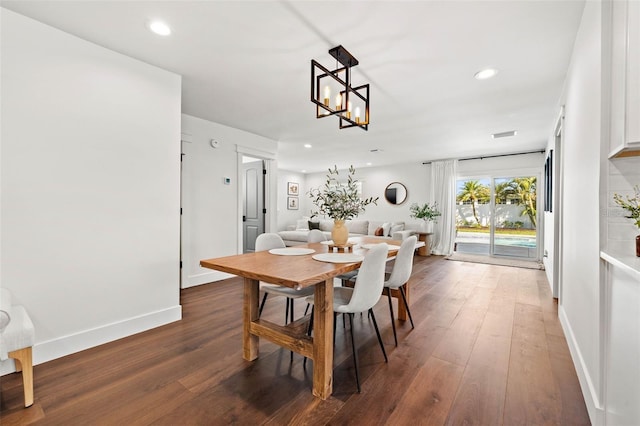 dining room featuring dark hardwood / wood-style flooring and a notable chandelier