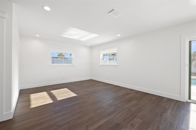 spare room with dark hardwood / wood-style floors