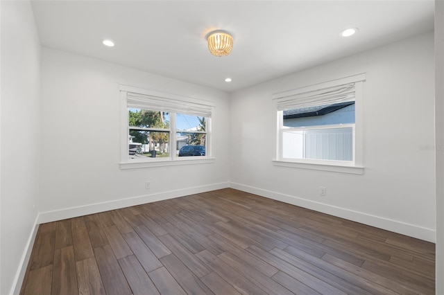 spare room featuring dark wood-type flooring