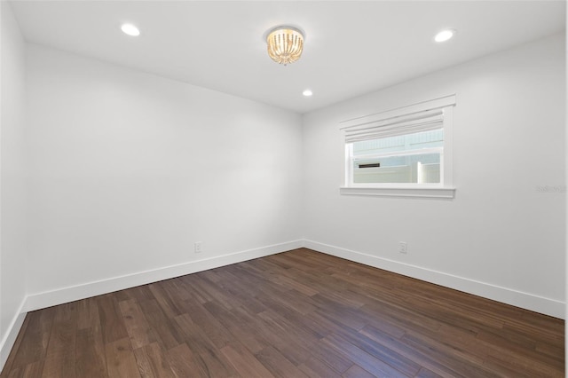 spare room with dark hardwood / wood-style floors