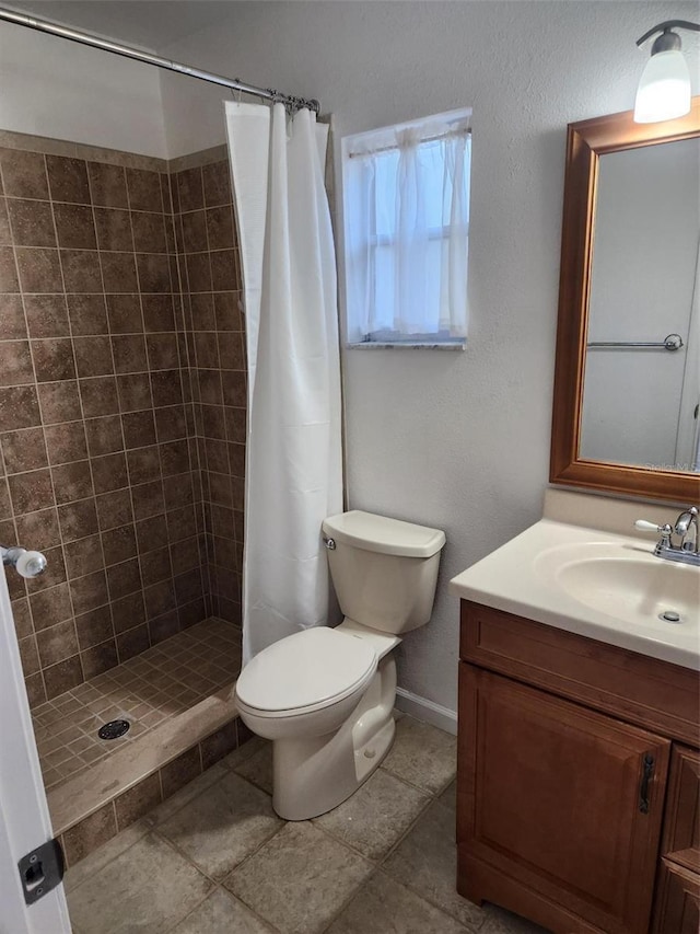 bathroom with vanity, toilet, and walk in shower