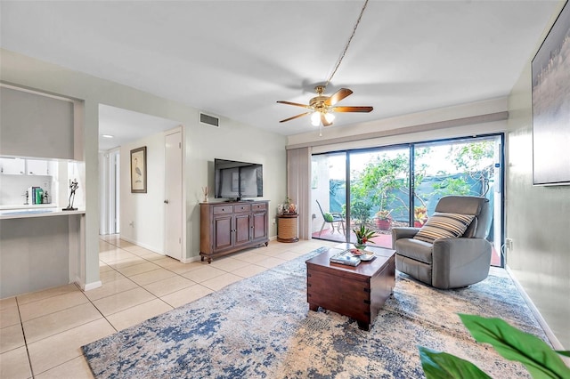 living room with ceiling fan and light tile patterned flooring