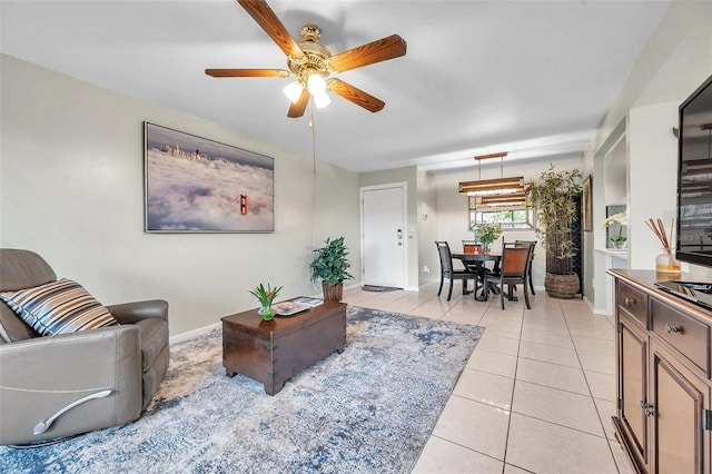 living room featuring ceiling fan and light tile patterned flooring