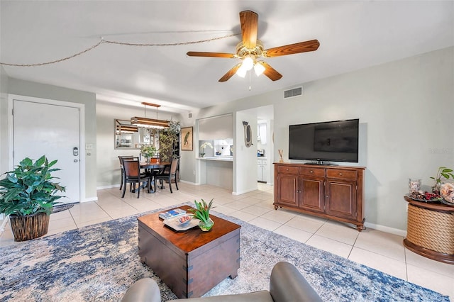 tiled living room with ceiling fan