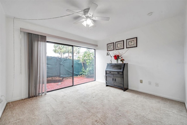 empty room featuring light carpet and ceiling fan