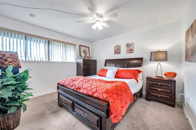 bedroom featuring ceiling fan and light carpet