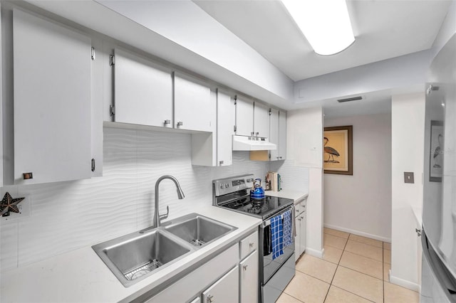 kitchen featuring backsplash, stainless steel electric stove, sink, light tile patterned floors, and white cabinetry