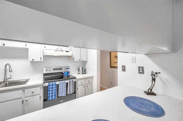 kitchen with white cabinetry, sink, backsplash, stainless steel electric stove, and dark tile patterned flooring