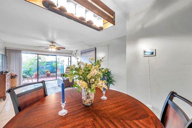 tiled dining space featuring ceiling fan