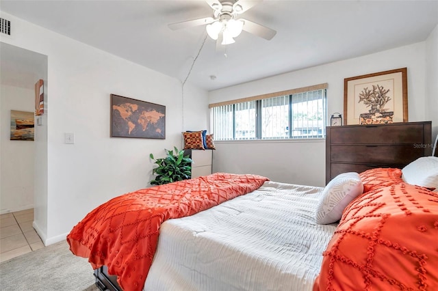 tiled bedroom featuring ceiling fan