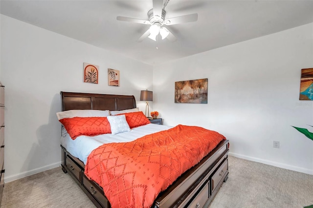 bedroom with ceiling fan and light carpet