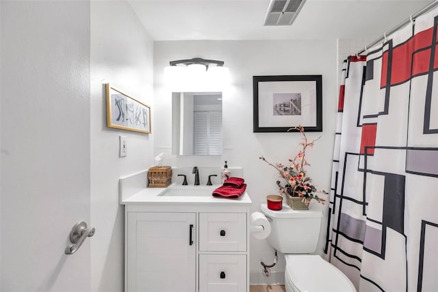 bathroom with vanity, toilet, and curtained shower