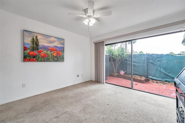 empty room featuring carpet flooring and ceiling fan