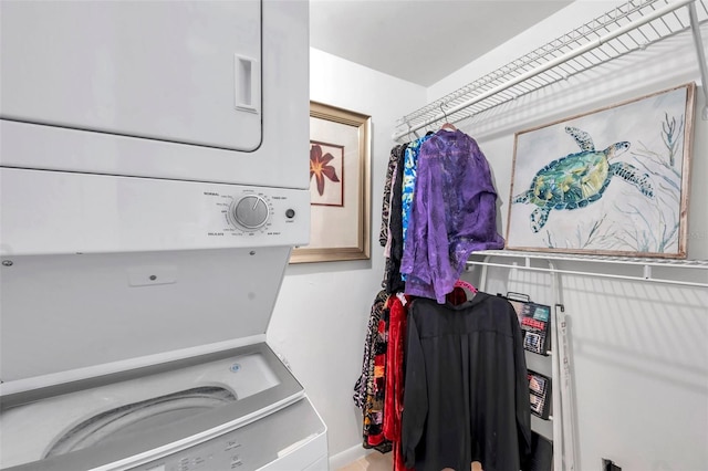 clothes washing area with stacked washer / dryer