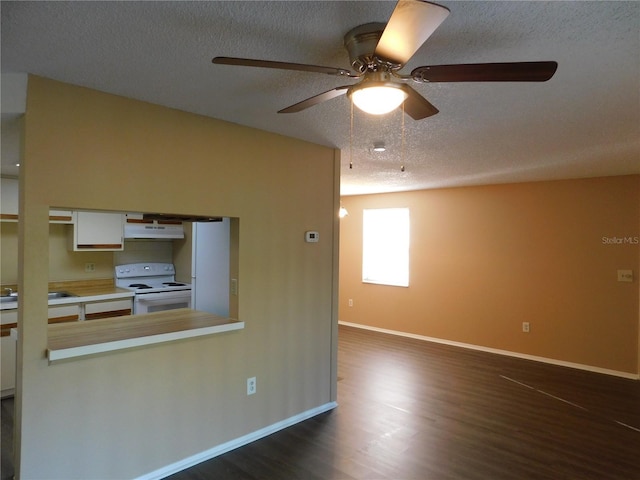 kitchen with white cabinets, dark hardwood / wood-style flooring, white electric range, and a textured ceiling