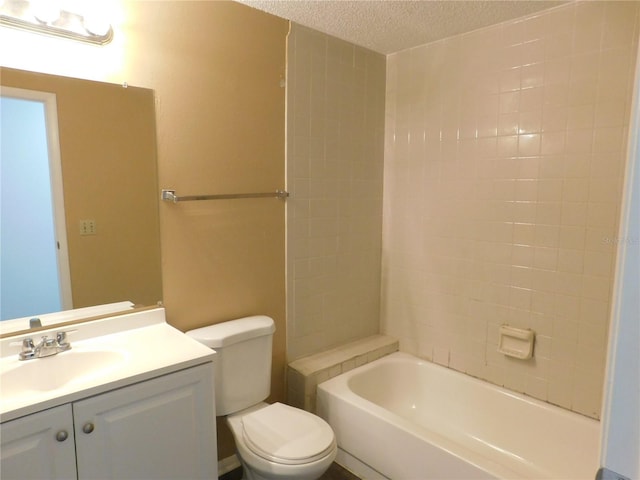 bathroom featuring vanity, toilet, and a textured ceiling